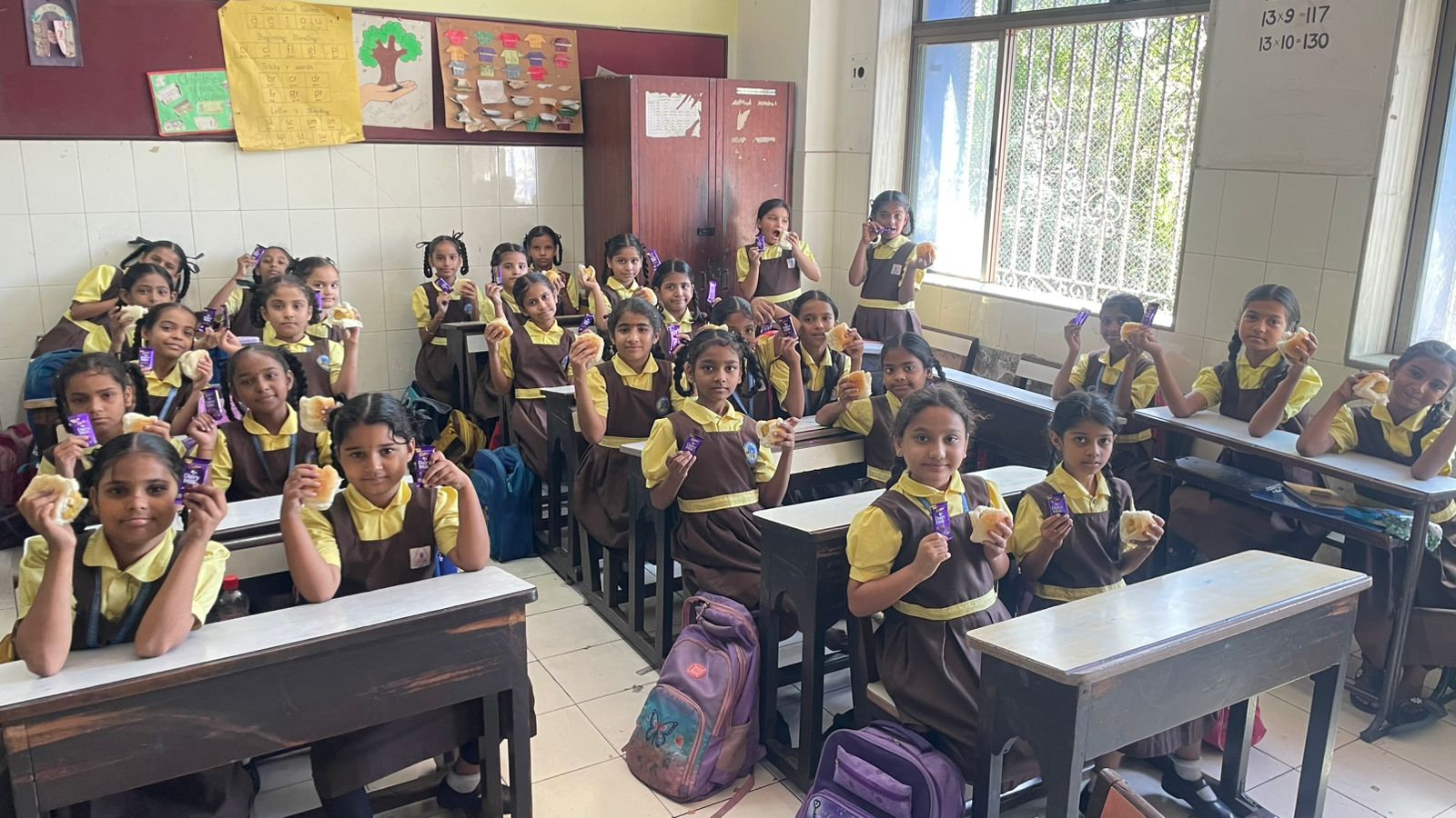 Students with vada pav and chocolate