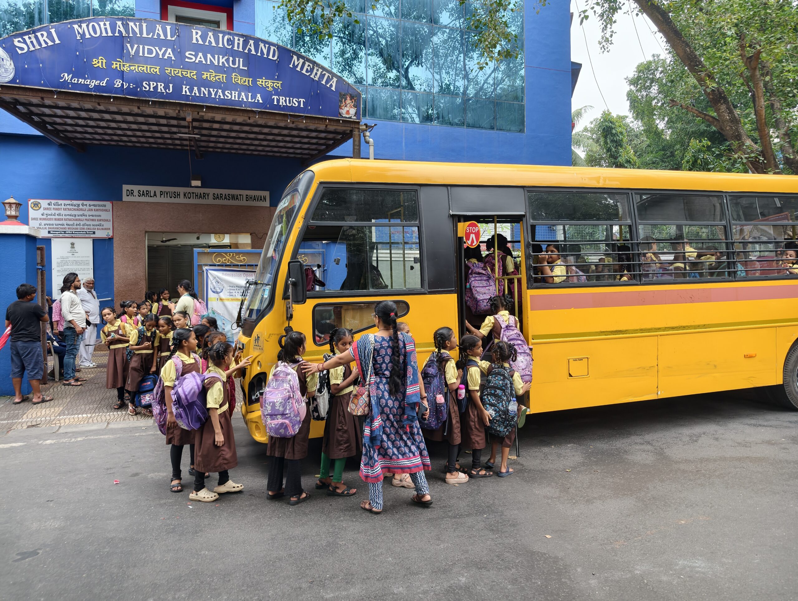 Teacher guiding and assisting school students safely