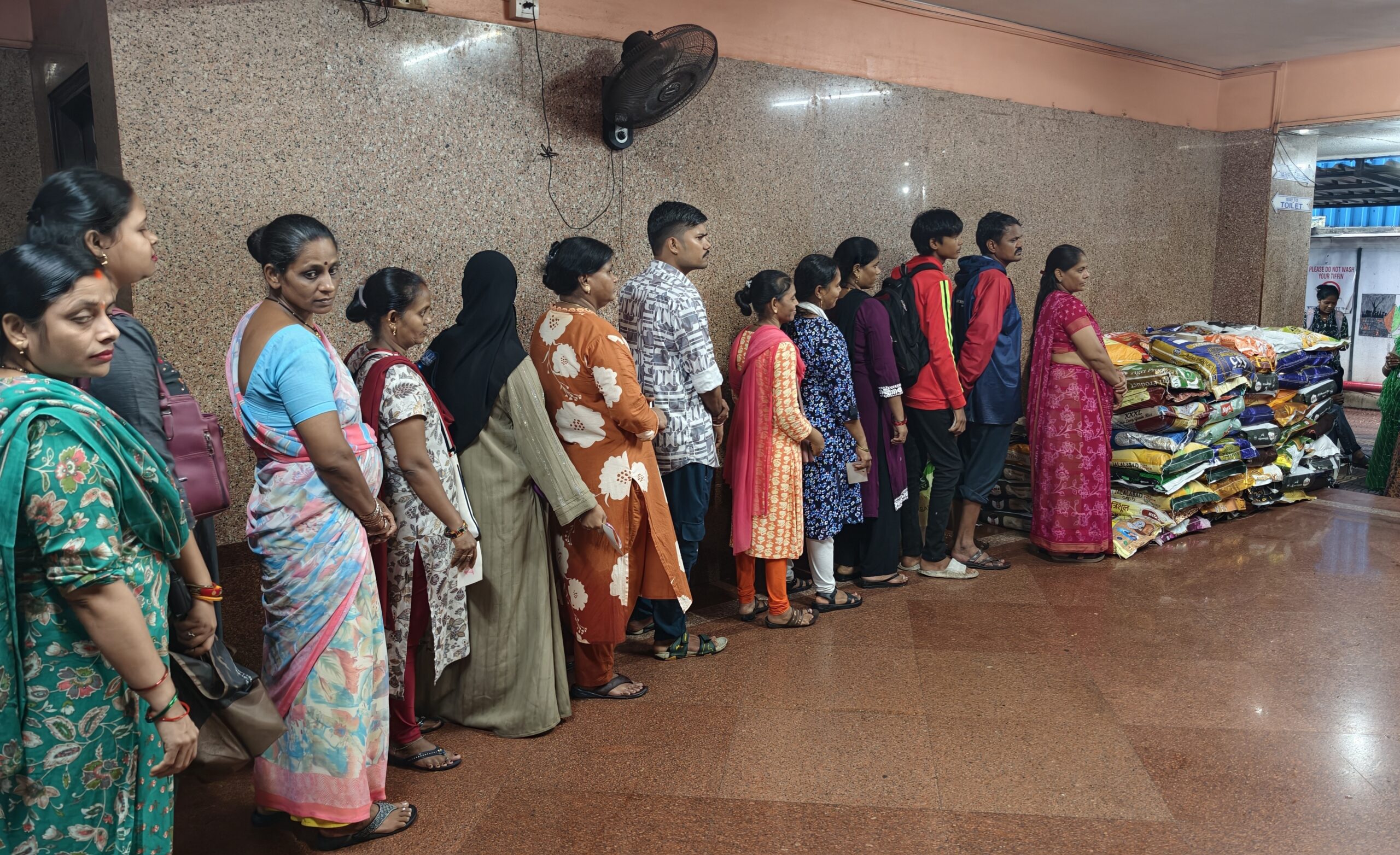 Parents waiting in line to collect their ration