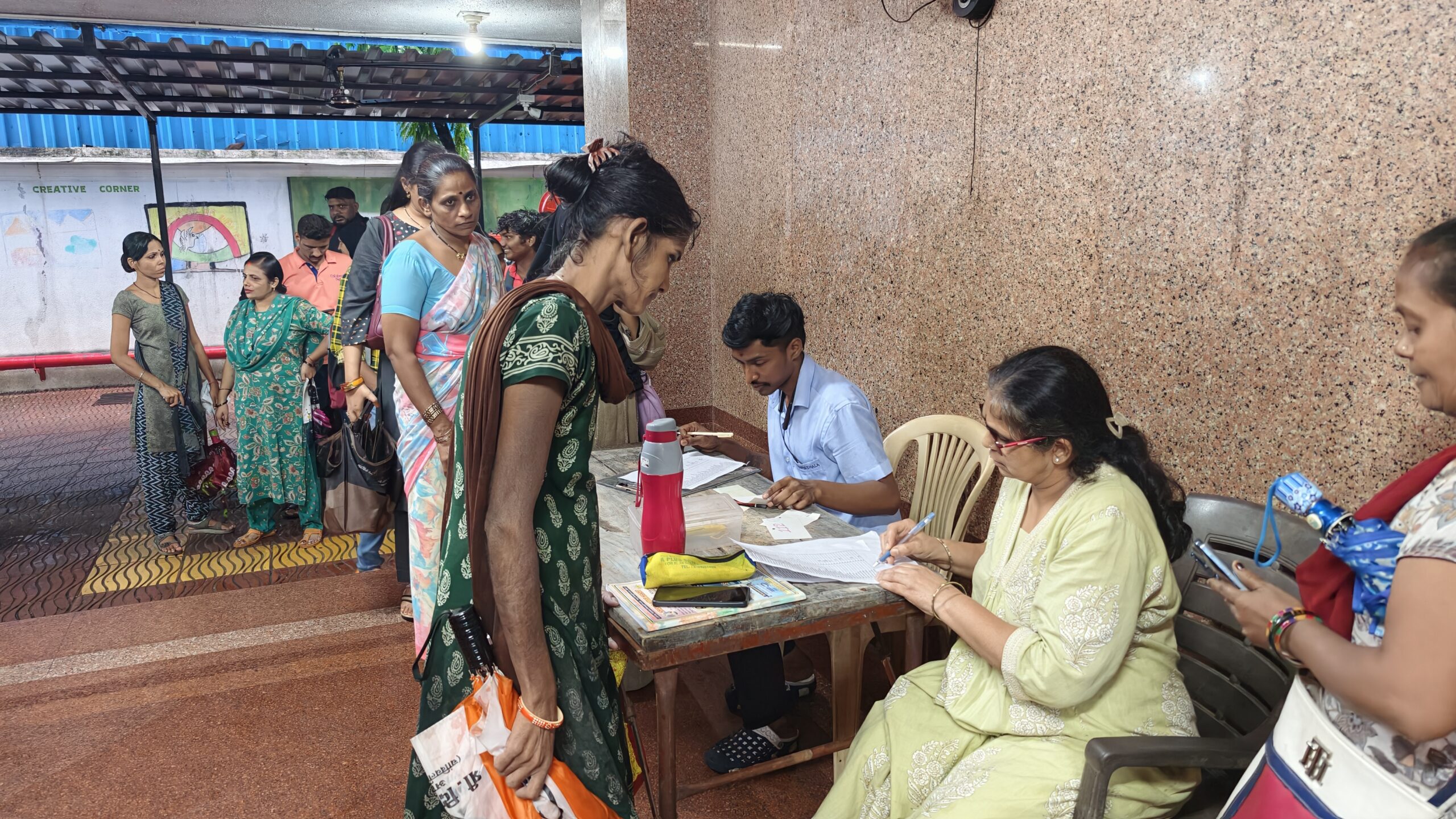 Teacher verifying the ration distribution list